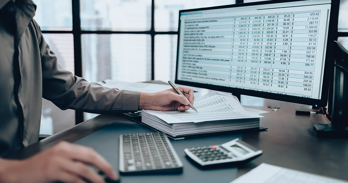 Investors working on desk office and using a pen and pointing to check tracking cost, balance, profit and currency. Accounting and Financial concept.