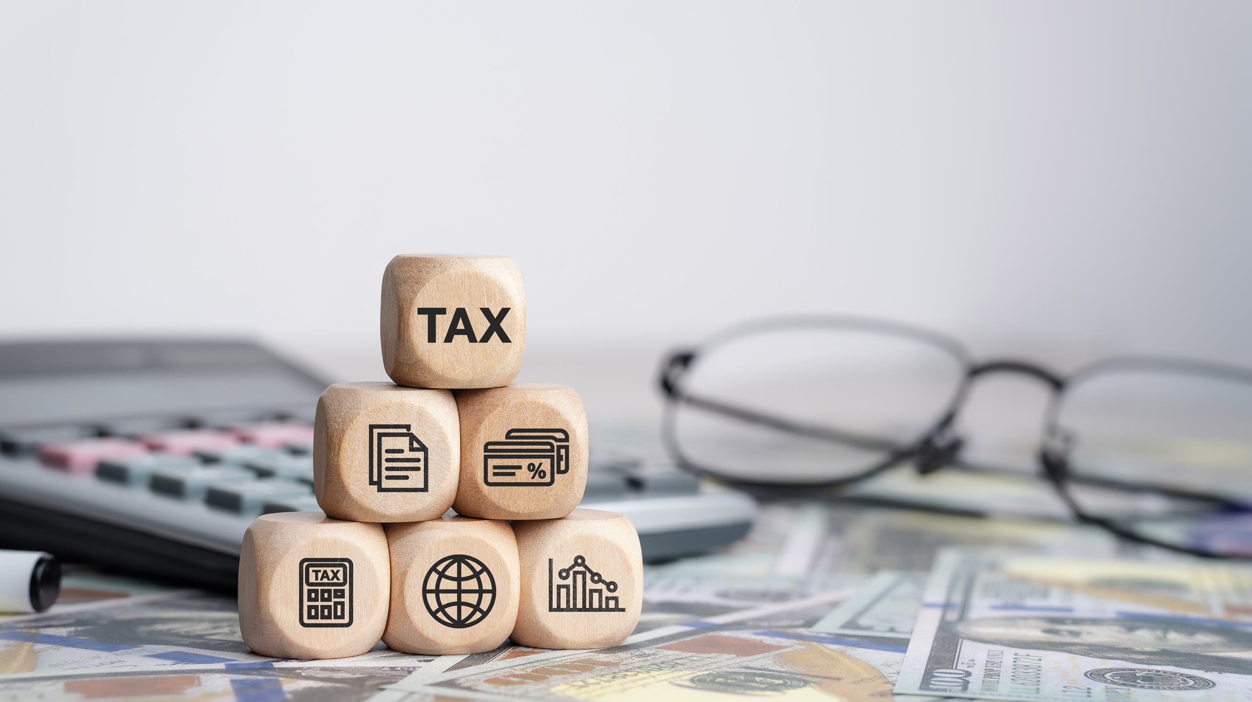 Calculator, glasses, tax cube